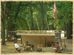 reenactors in a lean-to tent
